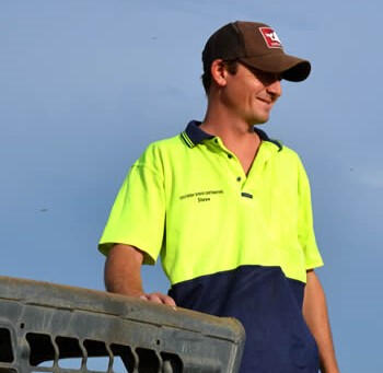 man in hi-vis shirt on bobcat